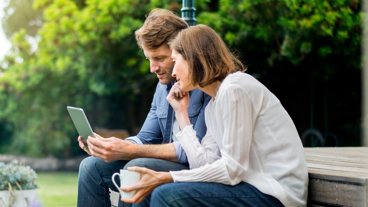 Couple reviewing their banking together on a tablet